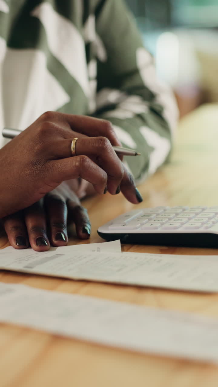 Close-up of Woman's Hands Calculating Finances on Desk
