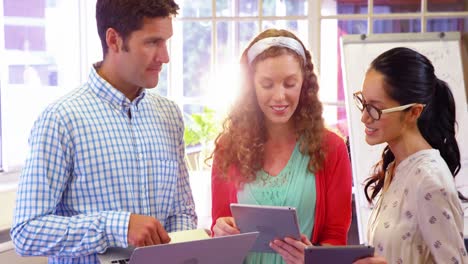 grupo de ejecutivos de negocios interactuando a través de tabletas digitales y computadoras portátiles