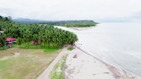 beach with a few houses and children playing in field