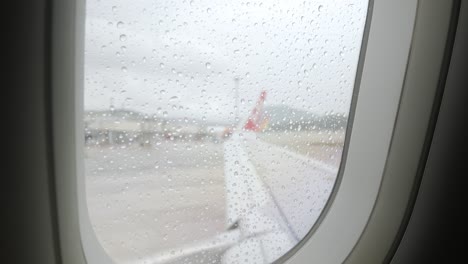 raindrop-on-the-window-surface-of-airplane-from-inside-cabin