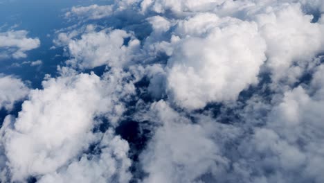 view from above bright cumulus clouds casting shadows on rippling ocean surface endless marine expanse below dynamic sky water contrast wide and open