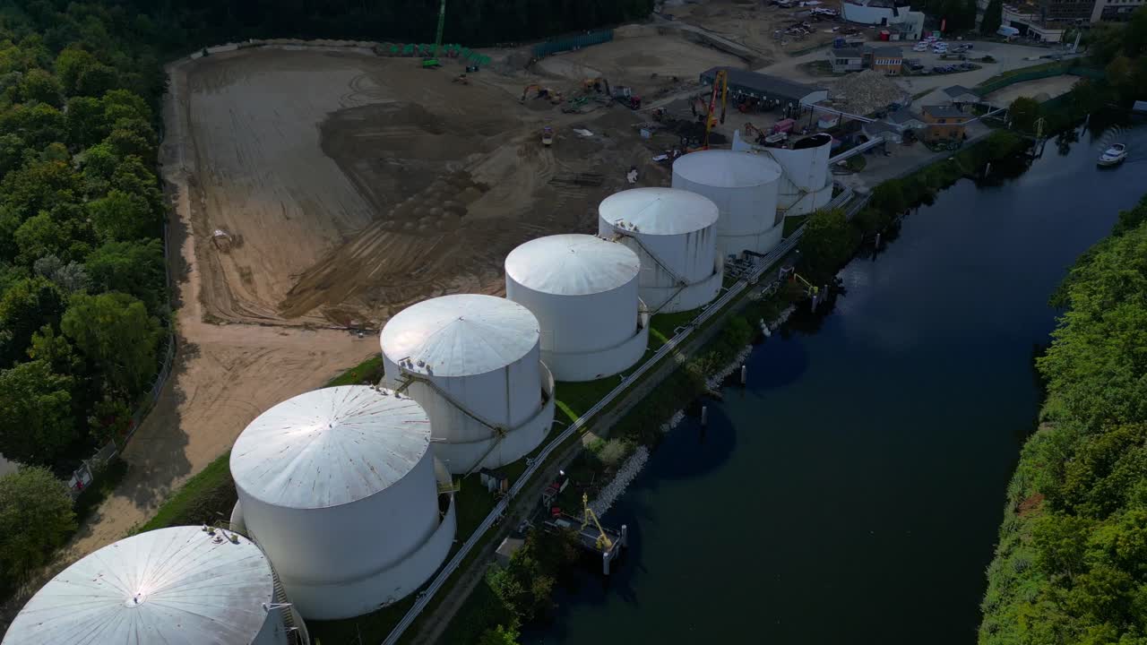 Decommissioning of Storage depot for petroleum products storage silos and containers. Industrial storage tanks holding oil and gas products. Unique aerial view flight descending drone