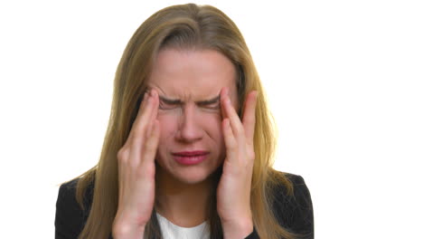 a close-up of a woman in pain from a headache-migraine, hands on either side of her temple of her head, on a seamless white studio background