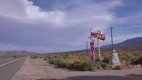 an abandoned or rundown old rustic motel along a rural road in america 1