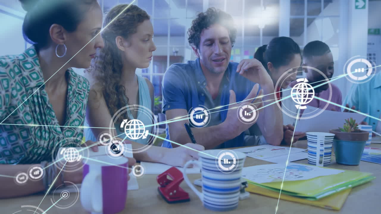 Collaborating at table, diverse team using animation and digital network in school