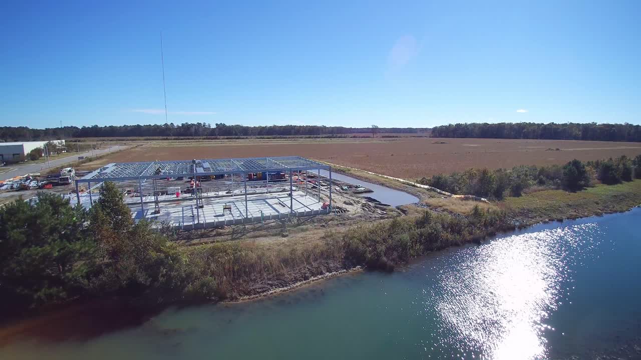 trabajadores trabajando en el suelo en un techo de una estructura esquelética un fin de semana con un mínimo de personas alrededor