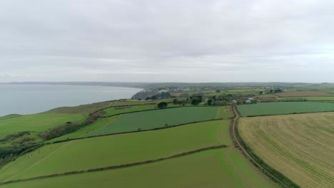 aerial tracking over coastal farmland in the perfect english countryside