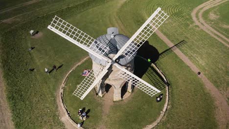 Chesterton-domed-Windmill-descending-aerial-view-above-wooden-sails-in-rural-countryside-meadow