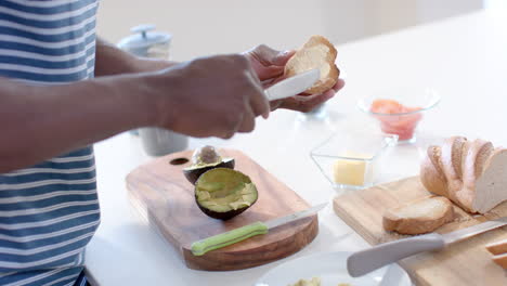 Young-African-American-man-preparing-breakfast-in-a-bright-kitchen