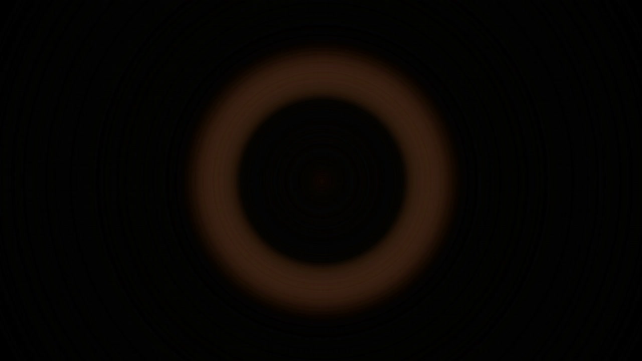 밝은 주황색 원이 깜박이고 검정색 배경에 대해 물러납니다.