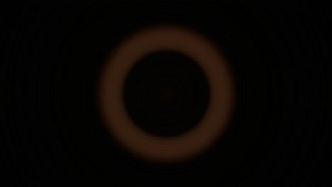 bright orange circles flash and recede against a black background