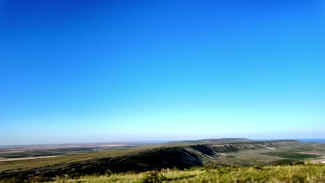 a beautiful view of the crimean landscape with a clear blue sky and green hills