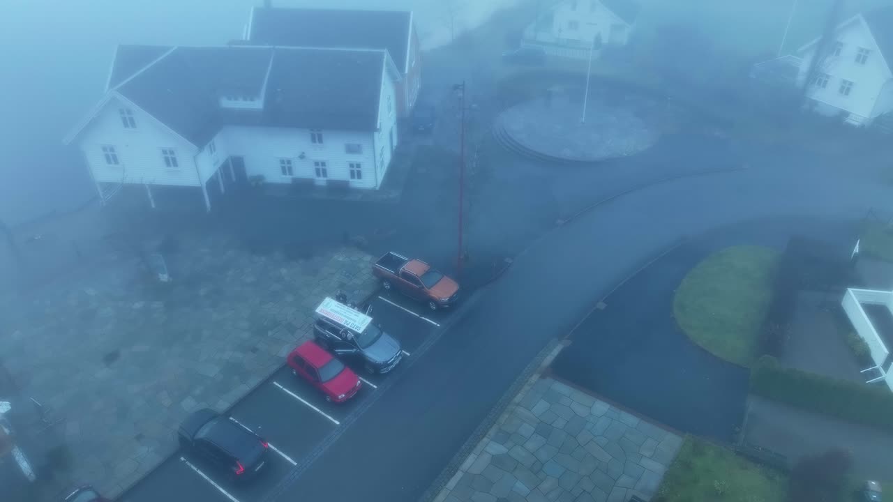 Aerial view of Norges Miljovernforbund vehicle and activists protesting wind turbines in foggy Modalen