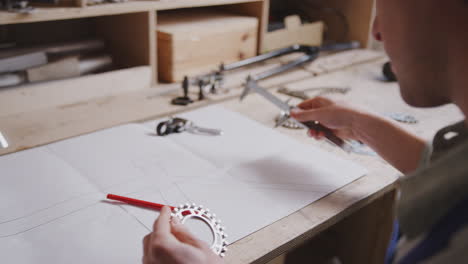 close up of engineer in workshop measuring components for bicycle with micrometer