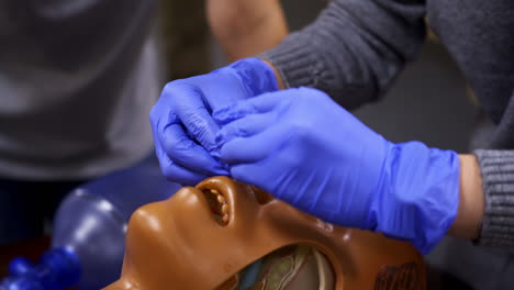 learning practice on a mannequin. specialist demonstrating medical procedure on a dummy head. training course. close-up.