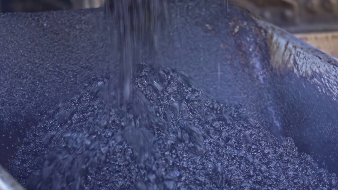 Closeup view of large amount of coal ore getting processed.