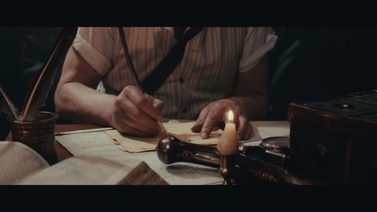 An old captain sits writes a letter inside the sailing ship cabin