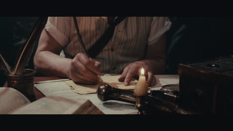an old captain sits writes a letter inside the sailing ship cabin