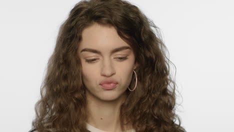 Capricious-woman-with-pouting-lips-in-studio.-Portrait-of-confused-girl-face