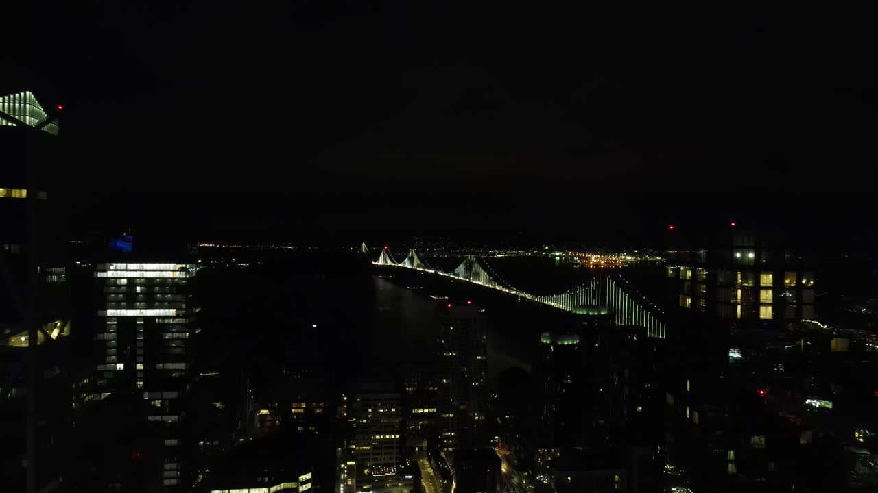 Aerial view of San Francisco&ndash;Oakland Bay Bridge by night, Financial district skyline, California, USA