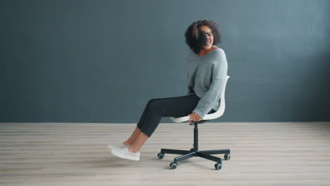 young woman sitting in an office chair