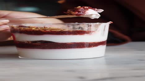 close-up of a delicious yogurt parfait with granola, chia seeds, and berries