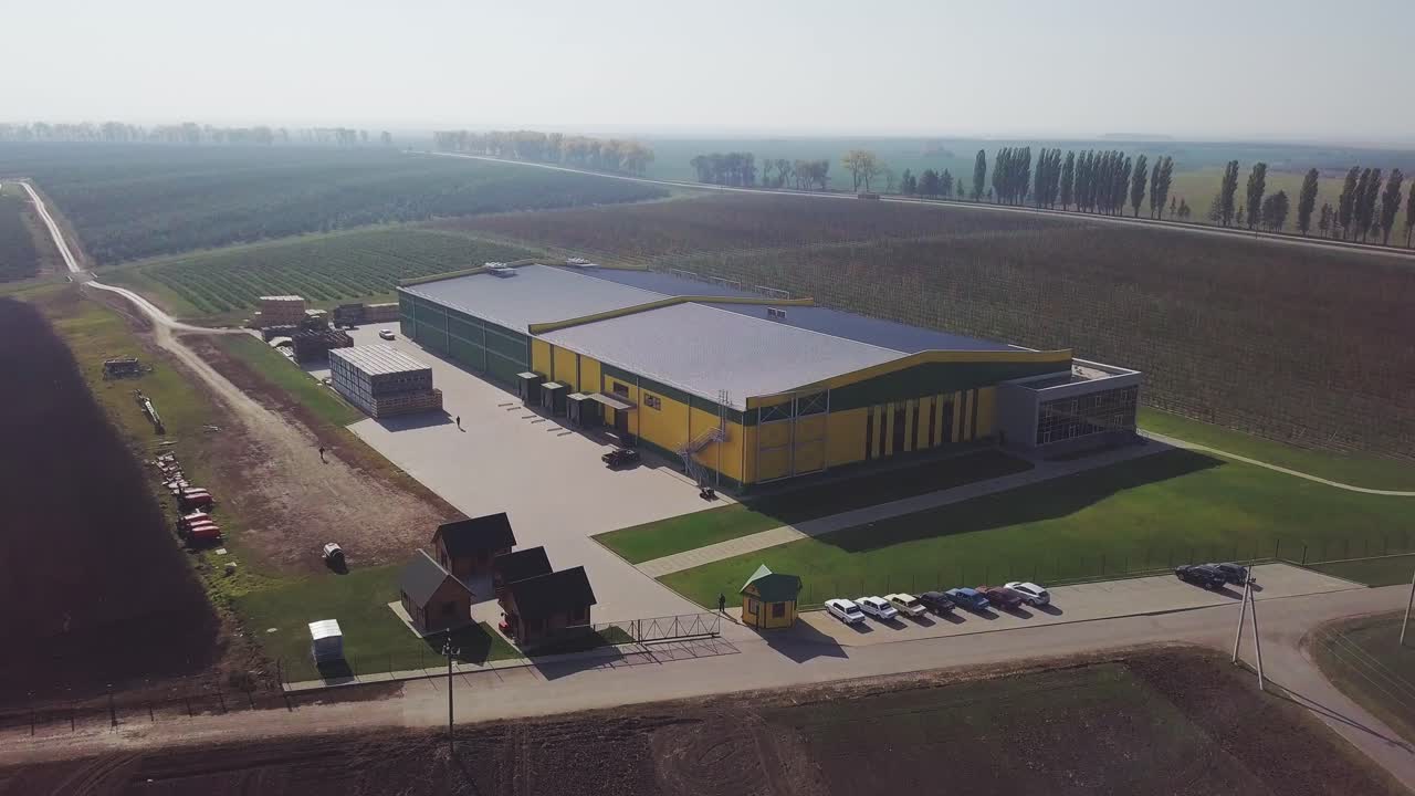 Aerial over fruit orchard farm showing different buildings to warehouse apples and pears also in background showing trees that grow the fresh fruit important food production site healthy food 4k