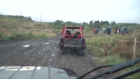 off-road vehicle race in muddy terrain