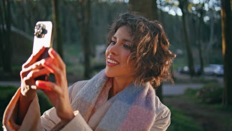 woman traveler taking picture sunny forest on cellphone closeup. girl recording