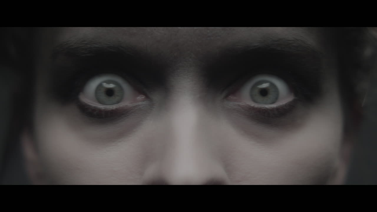 A woman dressed as mother opens her eyes