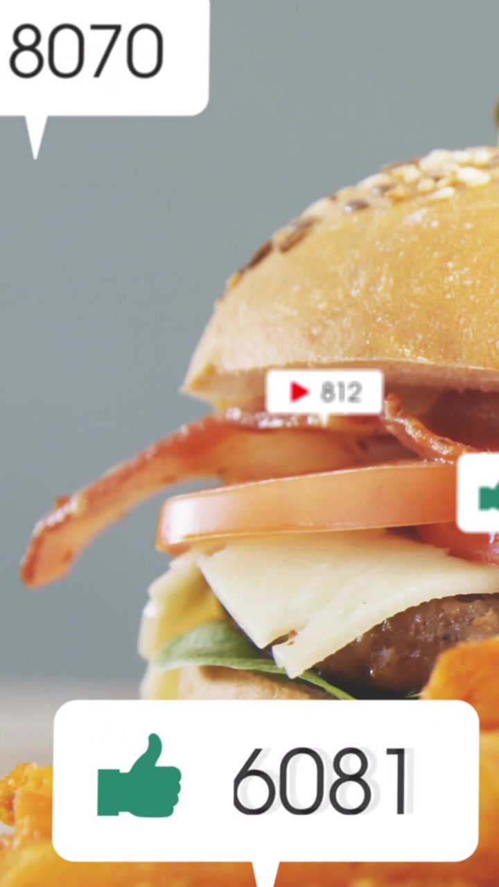 Vertical video: Social callouts popping, badges floating over burger stack, showing engagement rise