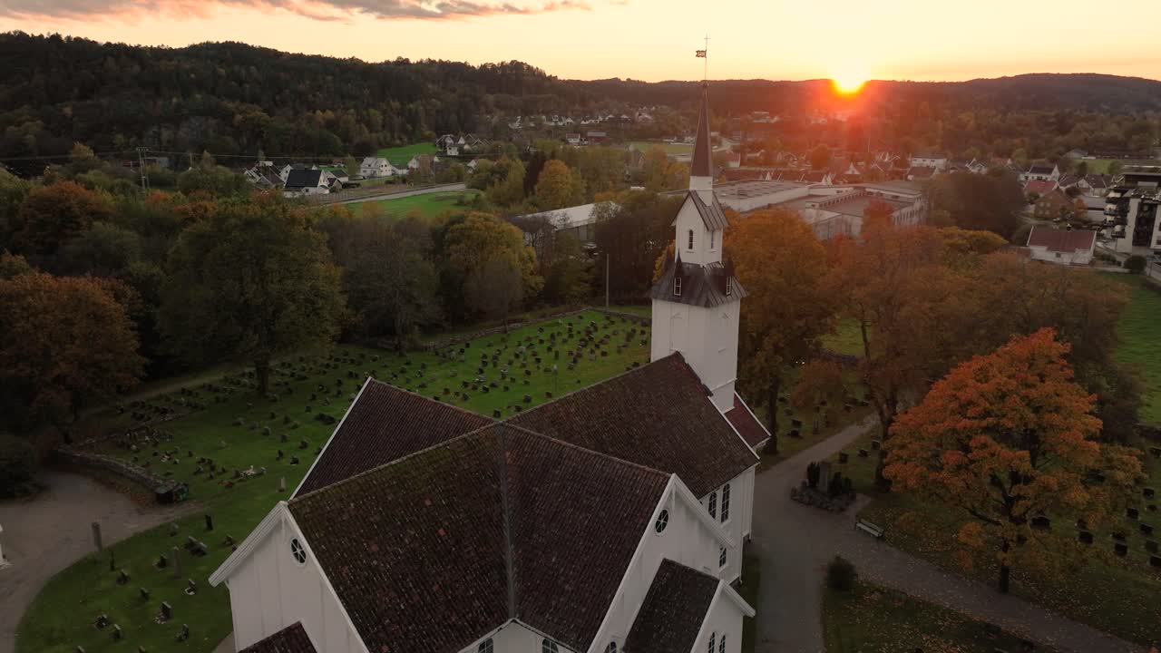 Aerial View of a Church and Cemetery at Sunset in Autumn