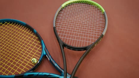 tennis rackets and balls on a court