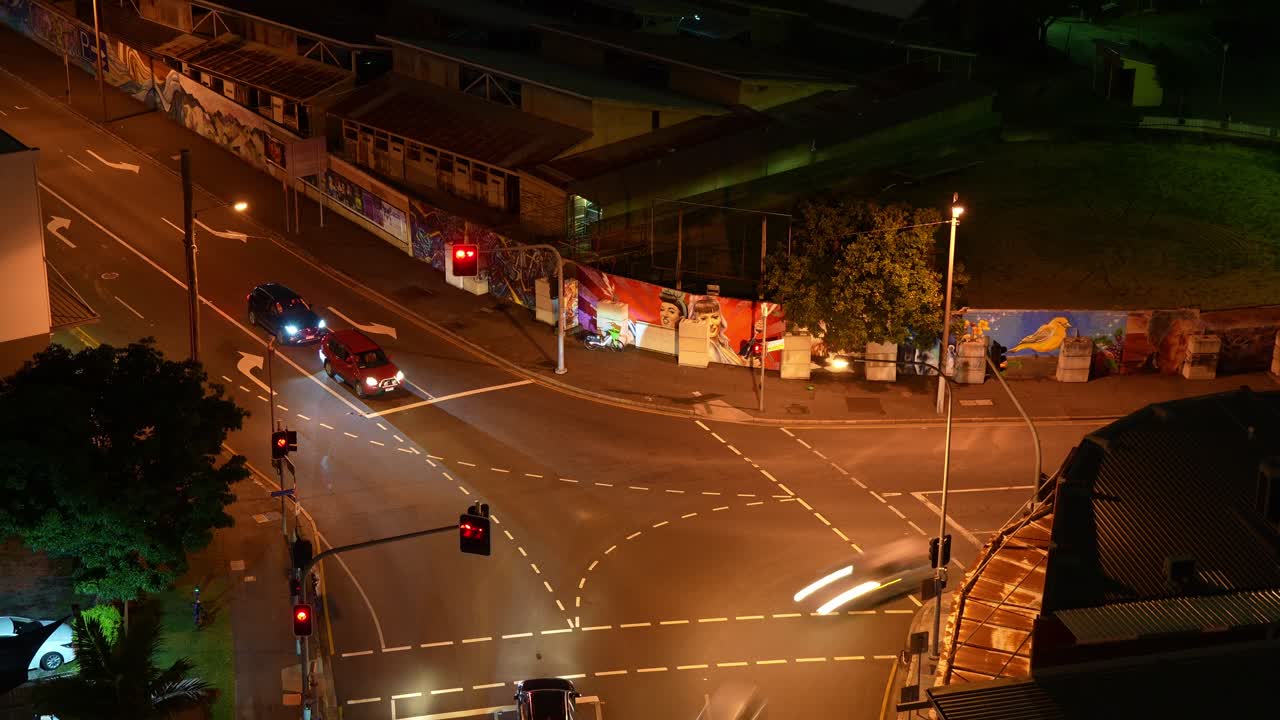 Night Traffic at a City Intersection with Murals