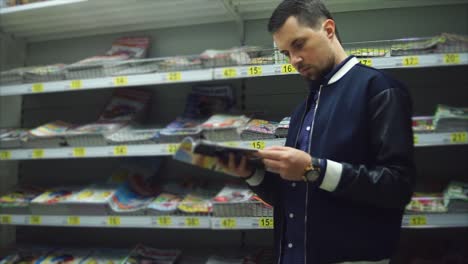 hombre leyendo una revista en una librería