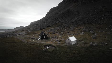 aerial abandoned house and chapel in rural rocky mountain landscape scenery