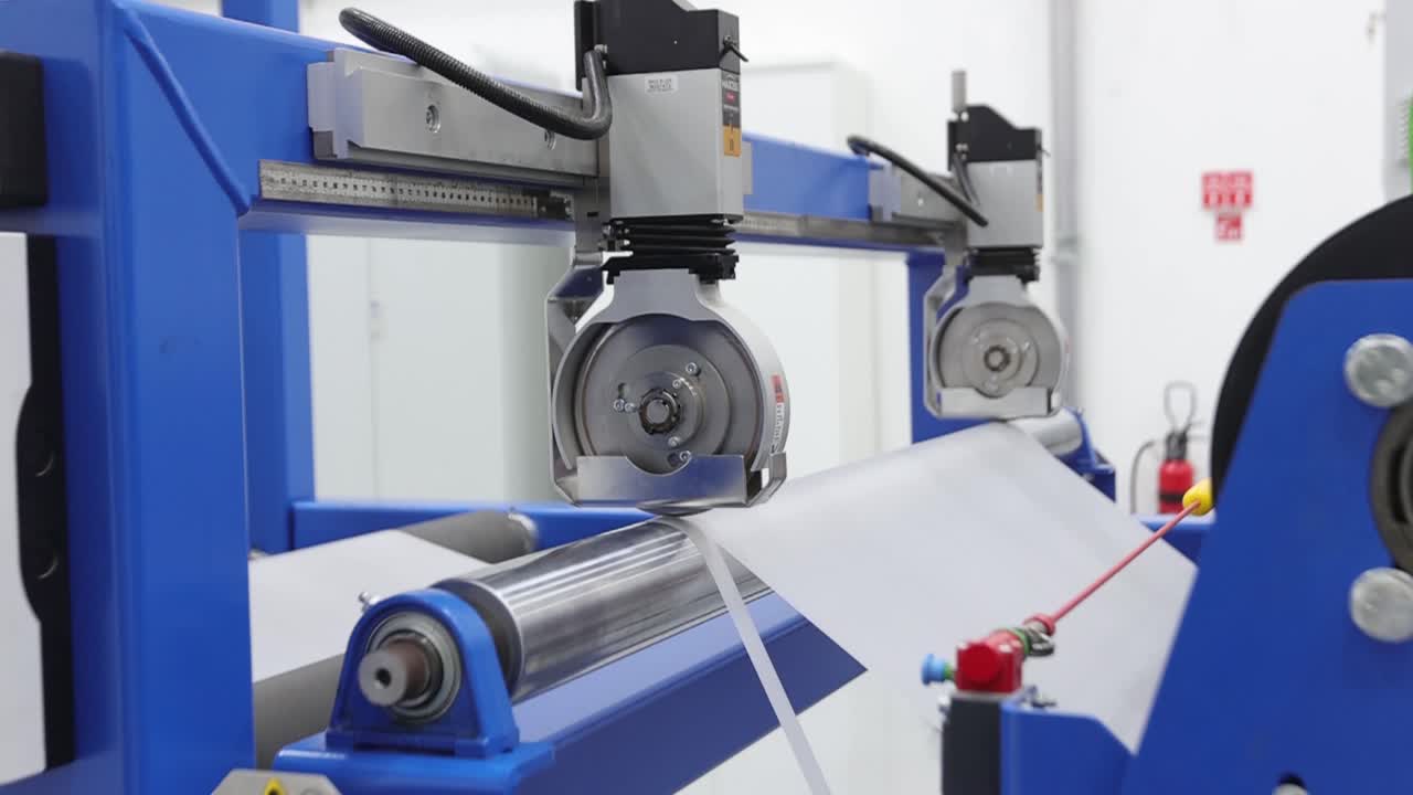 Worker preparing plastic grains for EVA film at extrusion machine