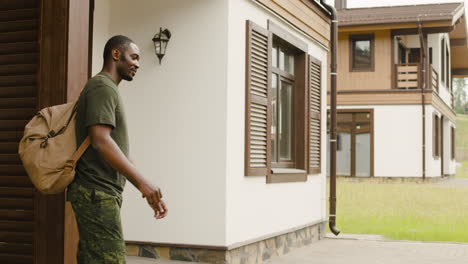 male soldier hugging and saying goodbye to his son outside home before going to military service