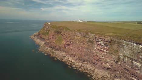 Aerial-view-flying-alongside-high-cliffs-near-St