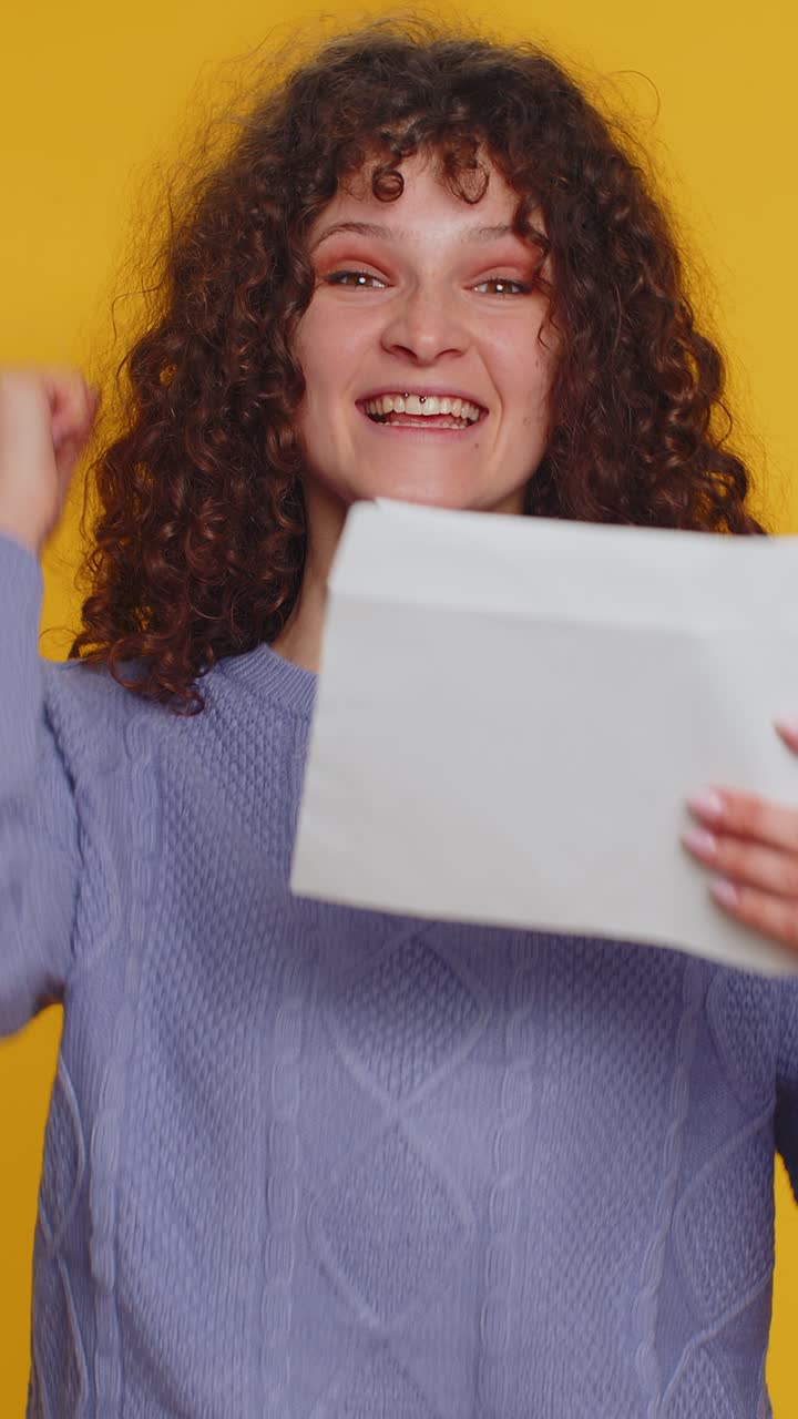 Young pretty student woman open envelope letter great news celebrate monetary award invitation