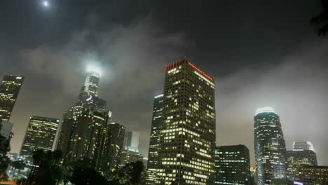 heavy traffic drives on a busy freeway in a city at night in downtown los angeles with fog rolling in 1