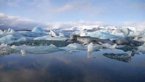 cinematic elevation shot of small icebergs found in jökulsárlón national park in iceland