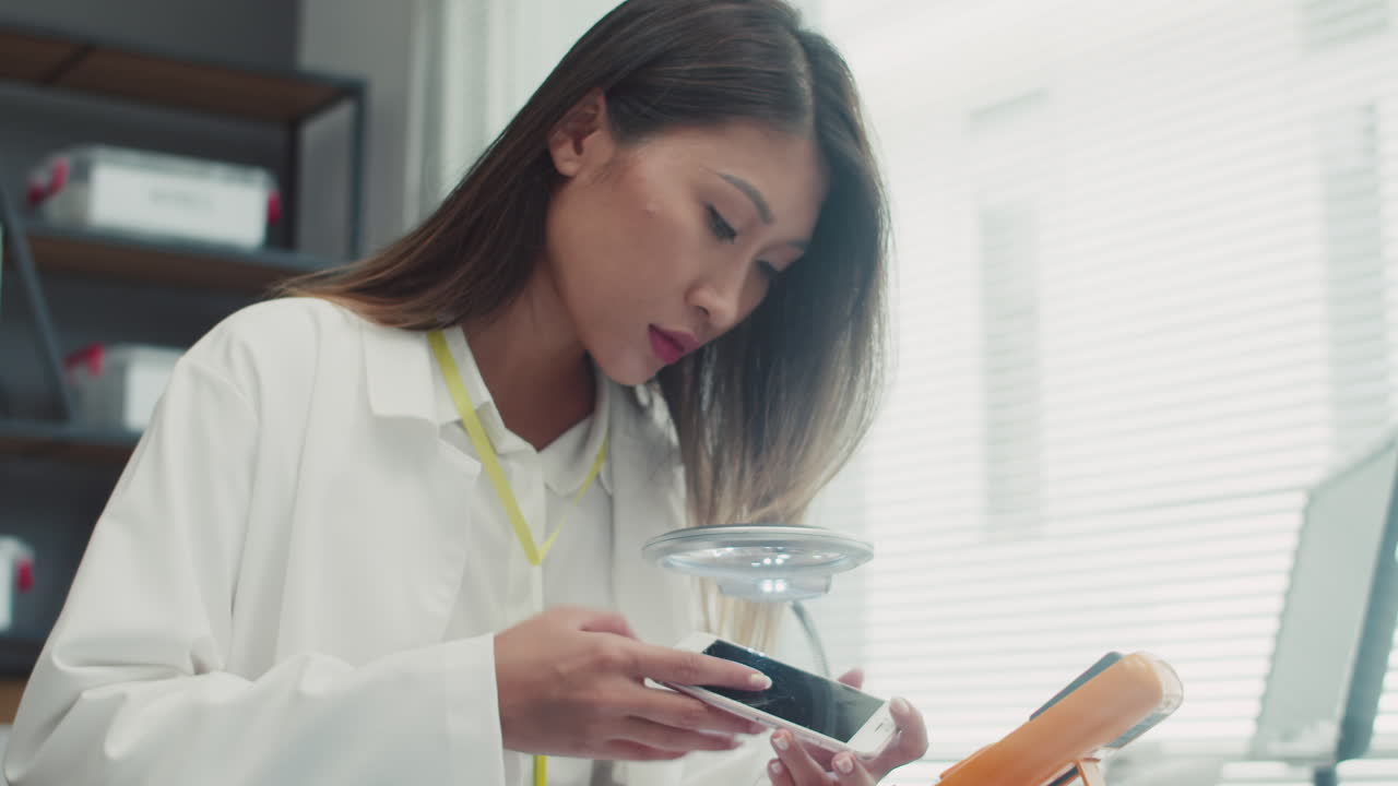 Specialist Working with Smartphone at Repair Center
