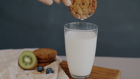dipping cookie in milk