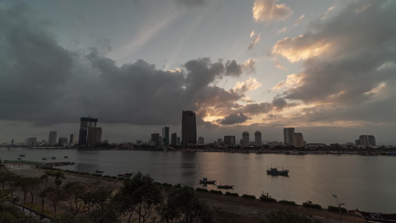 Cityscape at Sunset over River with Dramatic Clouds