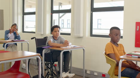 in school, diverse multiracial students listening attentively during lesson, engaged in learning