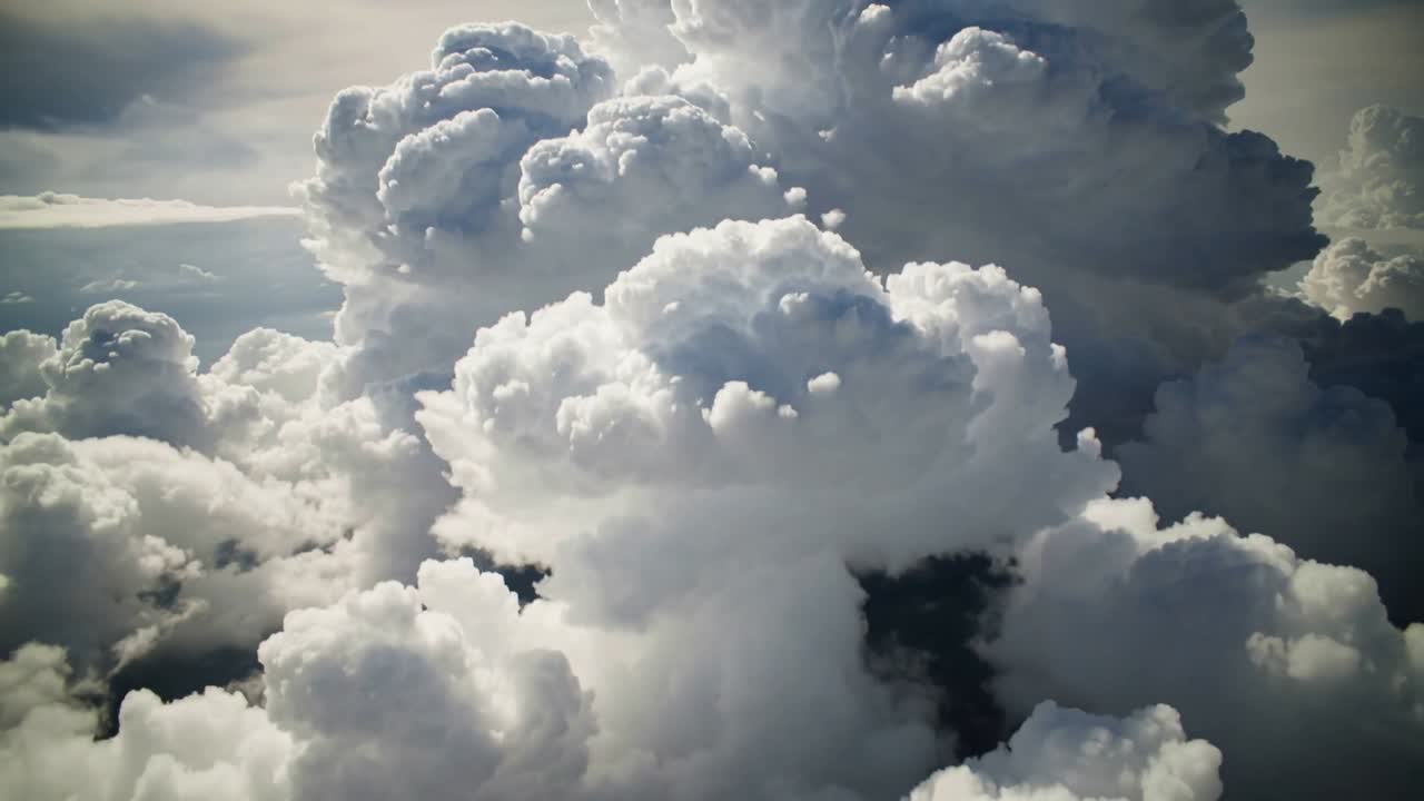 Approaching camera revealing towering cumulonimbus cloud mass at high-altitude, to show texture
