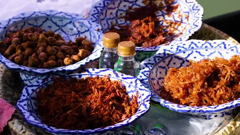 hands arranging food in decorative bowls outdoors