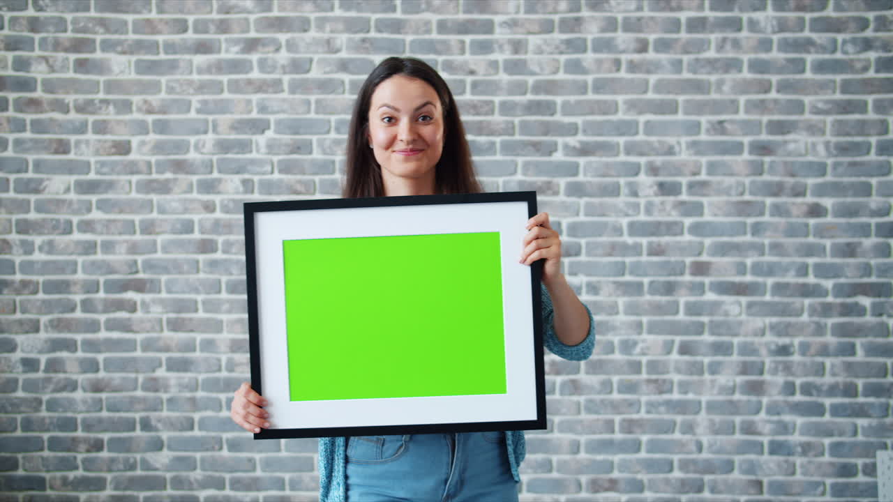 Woman Holding a Green Screen Frame