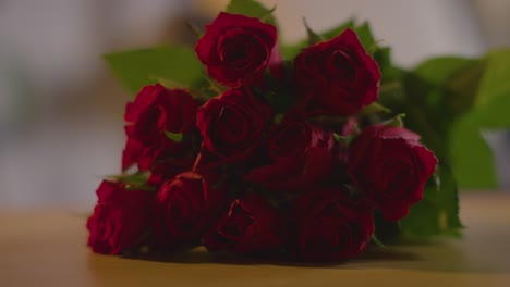 close up of bunch of red roses for valentines day on table 1